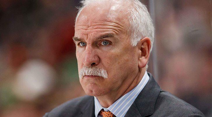 Colorado Avalanche head coach Joel Quenneville (R) wears his old