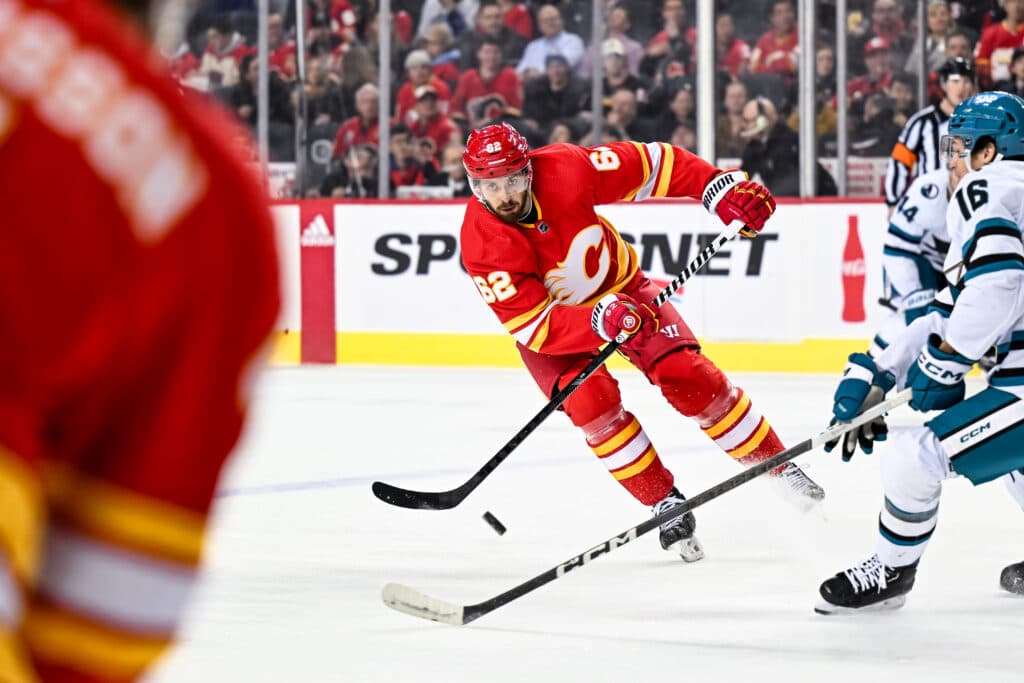 CALGARY, AB - APRIL 18: Calgary Flames Defenceman Daniil Miromanov (62) passes the puck during the first period of an NHL game between the Calgary Flames and the San Jose Sharks on April 18, 2024, at the Scotiabank Saddledome in Calgary, AB. (Photo by Brett Holmes/Icon Sportswire via Getty Images)