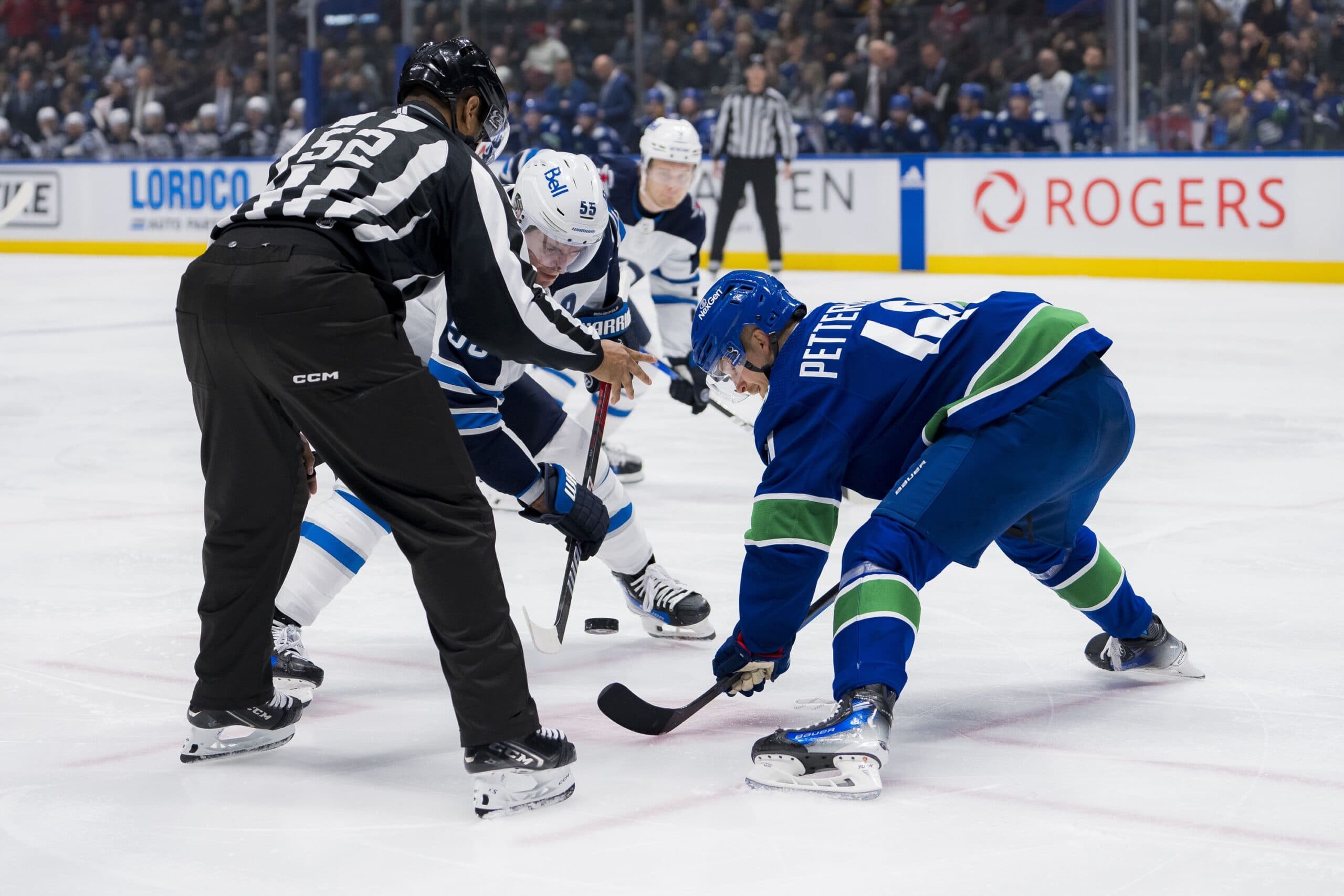 Vancouver Canucks center Elias Pettersson and Winnipeg Jets center Mark Scheifele.