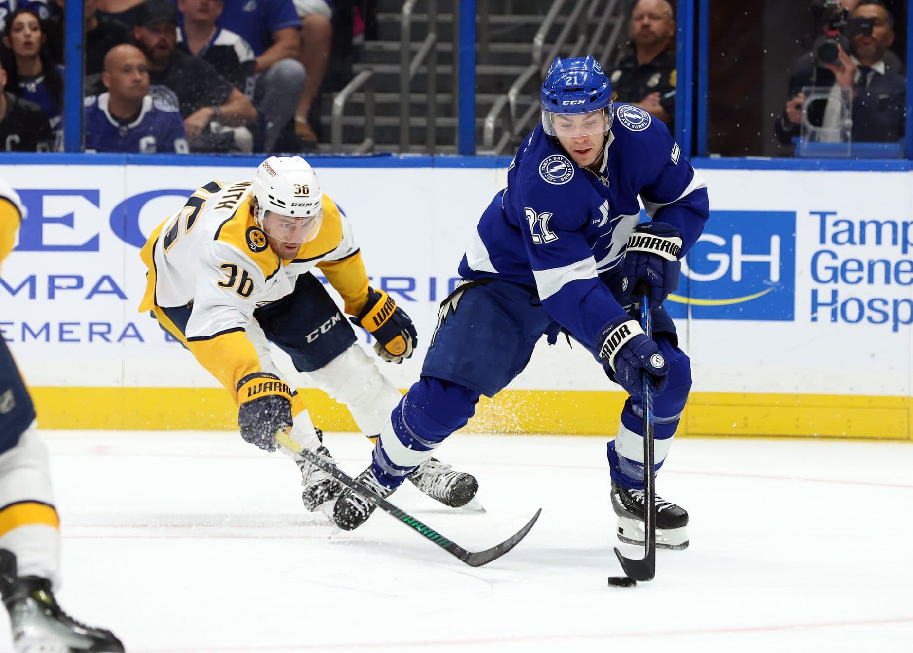 Tampa Bay Lightning center Brayden Point (21) skates with the puck as Nashville Predators left wing Cole Smith (36) defends during the first period at Amalie Arena.