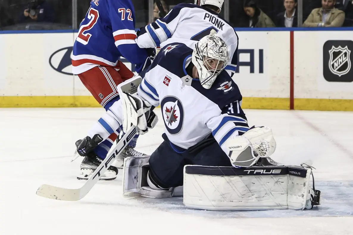 Winnipeg Jets goaltender Connor Hellebuyck (37) makes a save on a shot on goal attempt in the second period against the New York Rangers at Madison Square Garden