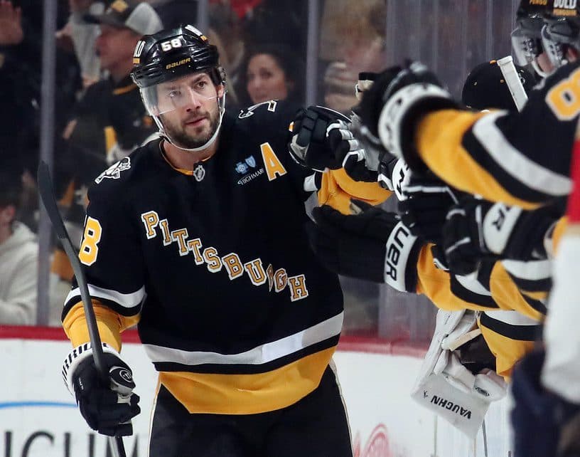 Pittsburgh Penguins defenseman Kris Letang (58) celebrates his goal with the bench against the Florida Panthers during the second period at PPG Paints Arena.