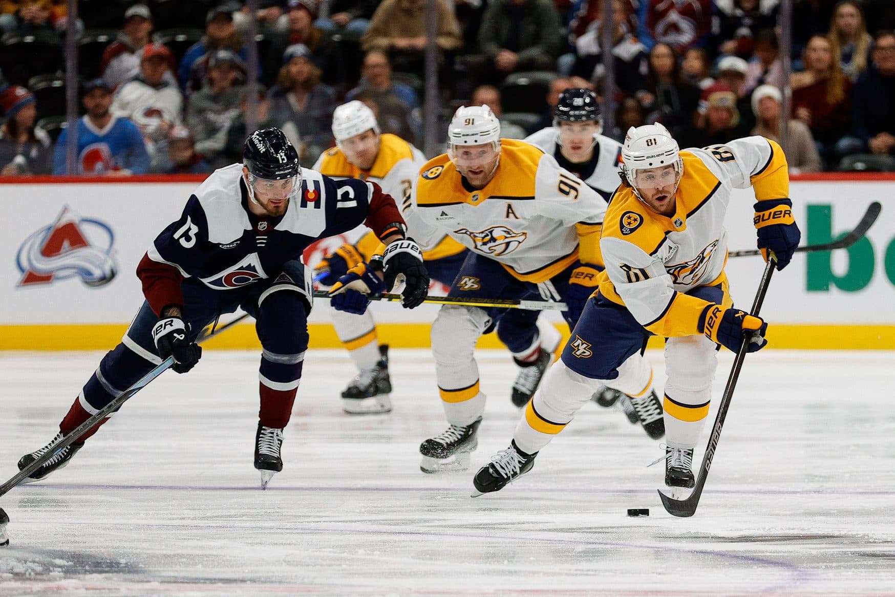 Nashville Predators center Jonathan Marchessault (81) controls the puck ahead of center Steven Stamkos (91) and Colorado Avalanche right wing Valeri Nichushkin (13) in the first period at Ball Arena.