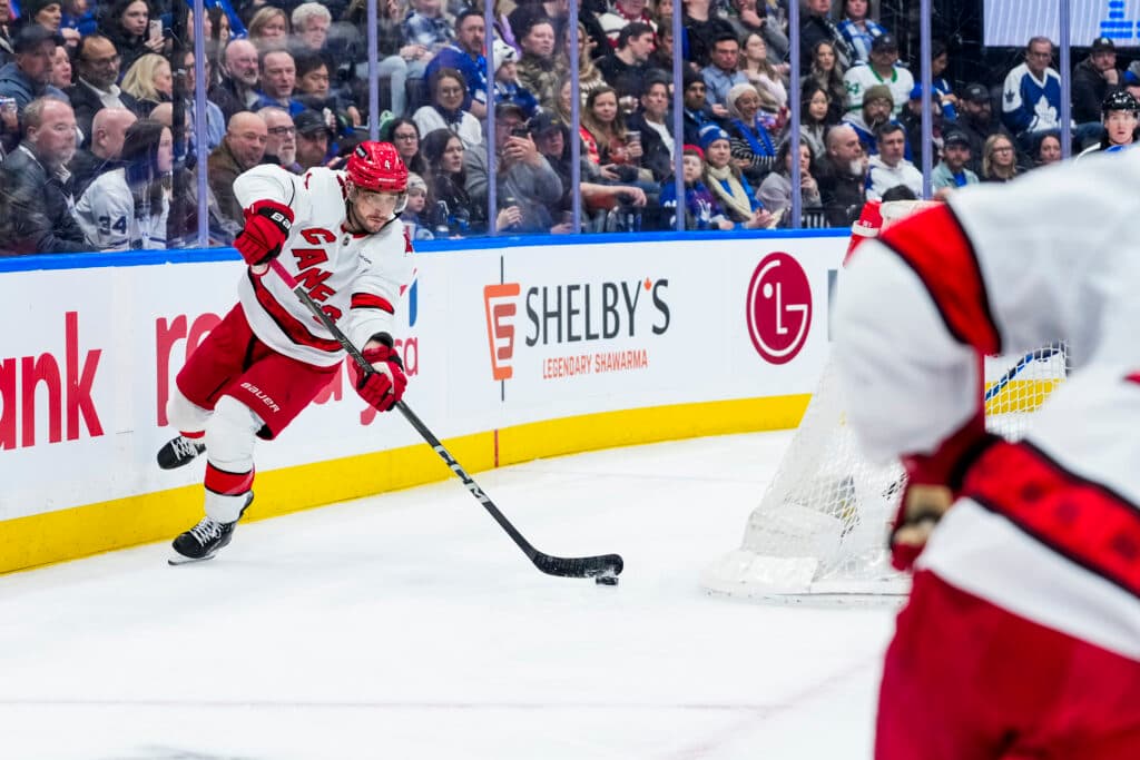 TORONTO, ON - FEBRUARY 22:  Shayne Gostisbehere #4 of the Carolina Hurricanes makes a pass during the second period against the Toronto Maple Leafs at the Scotiabank Arena on February 22, 2025 in Toronto, Ontario, Canada. (Photo by Mark Blinch/NHLI via Getty Images)