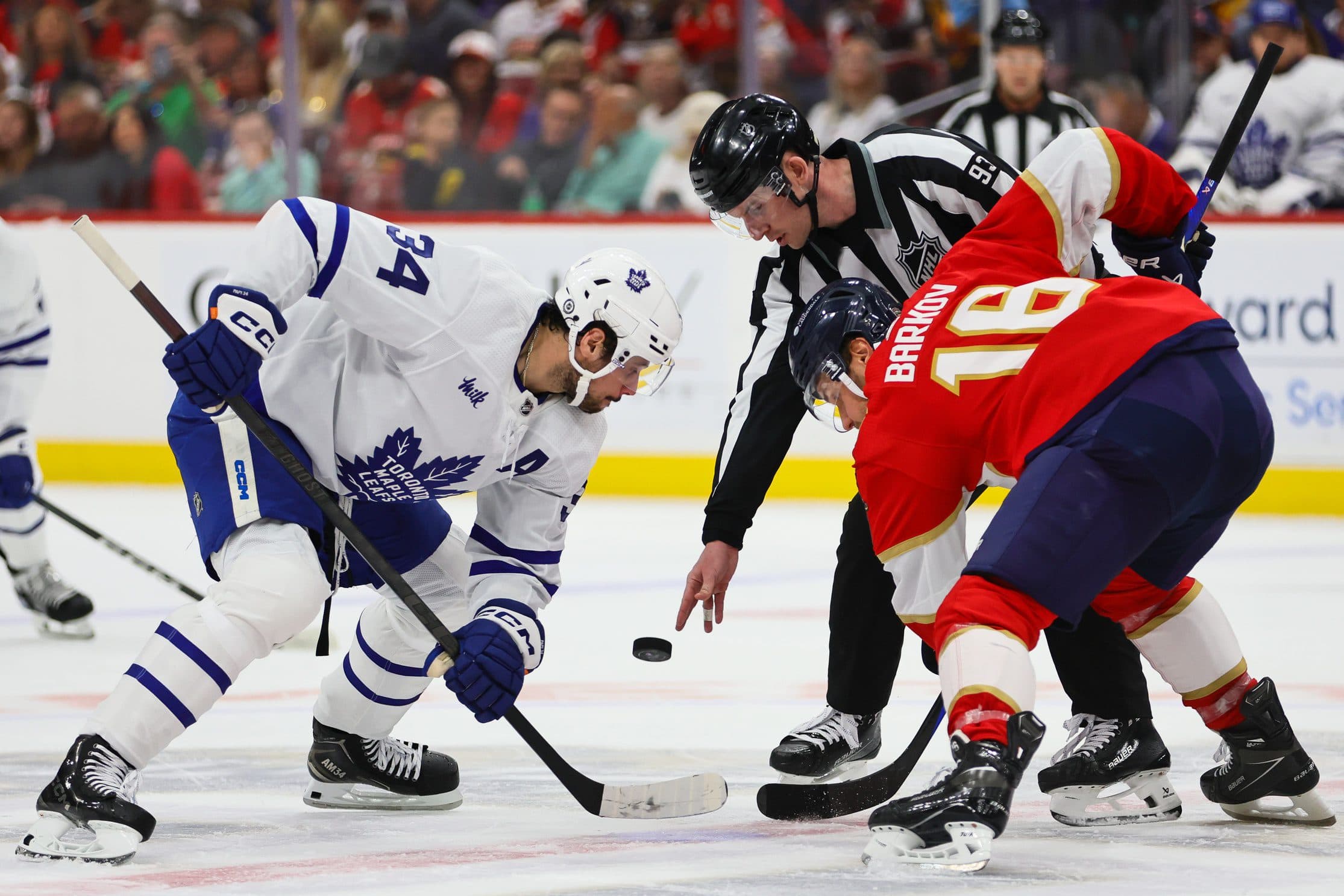 Toronto Maple Leafs center Auston Matthews (34) and Florida Panthers center Aleksander Barkov (16) face-off during the first period at Amerant Bank Arena