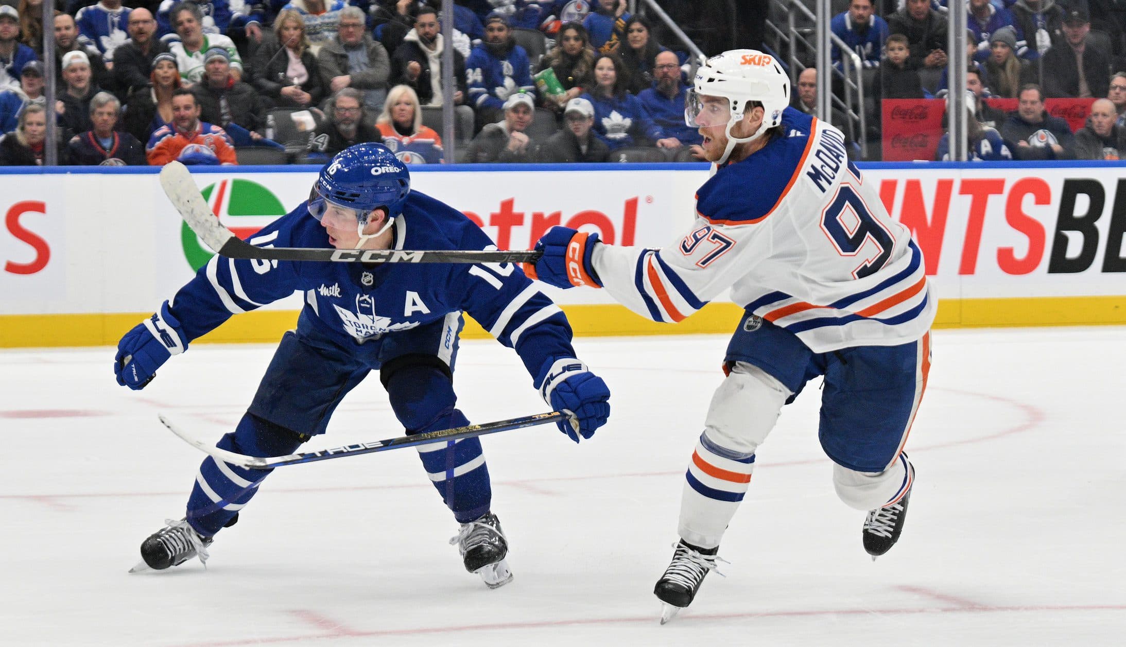 Edmonton Oilers forward Connor McDavid (97) shoots the puck against Toronto Maple Leafs forward Mitch Marner (16) in overtime at Scotiabank Arena.