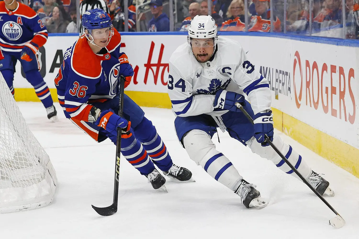 Toronto Maple Leafs forward Auston Matthews (34) protects the puck from Edmonton Oilers defensemen John Klingberg (36) during the second period at Rogers Place.