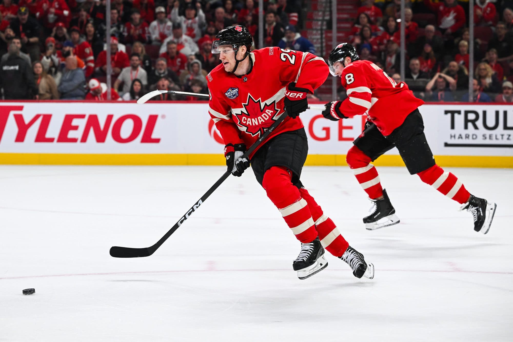 Team Canada forward Nathan MacKinnon (29) plays the puck against Team Sweden in overtime during a 4 Nations Face-Off ice hockey game at Bell Centre.