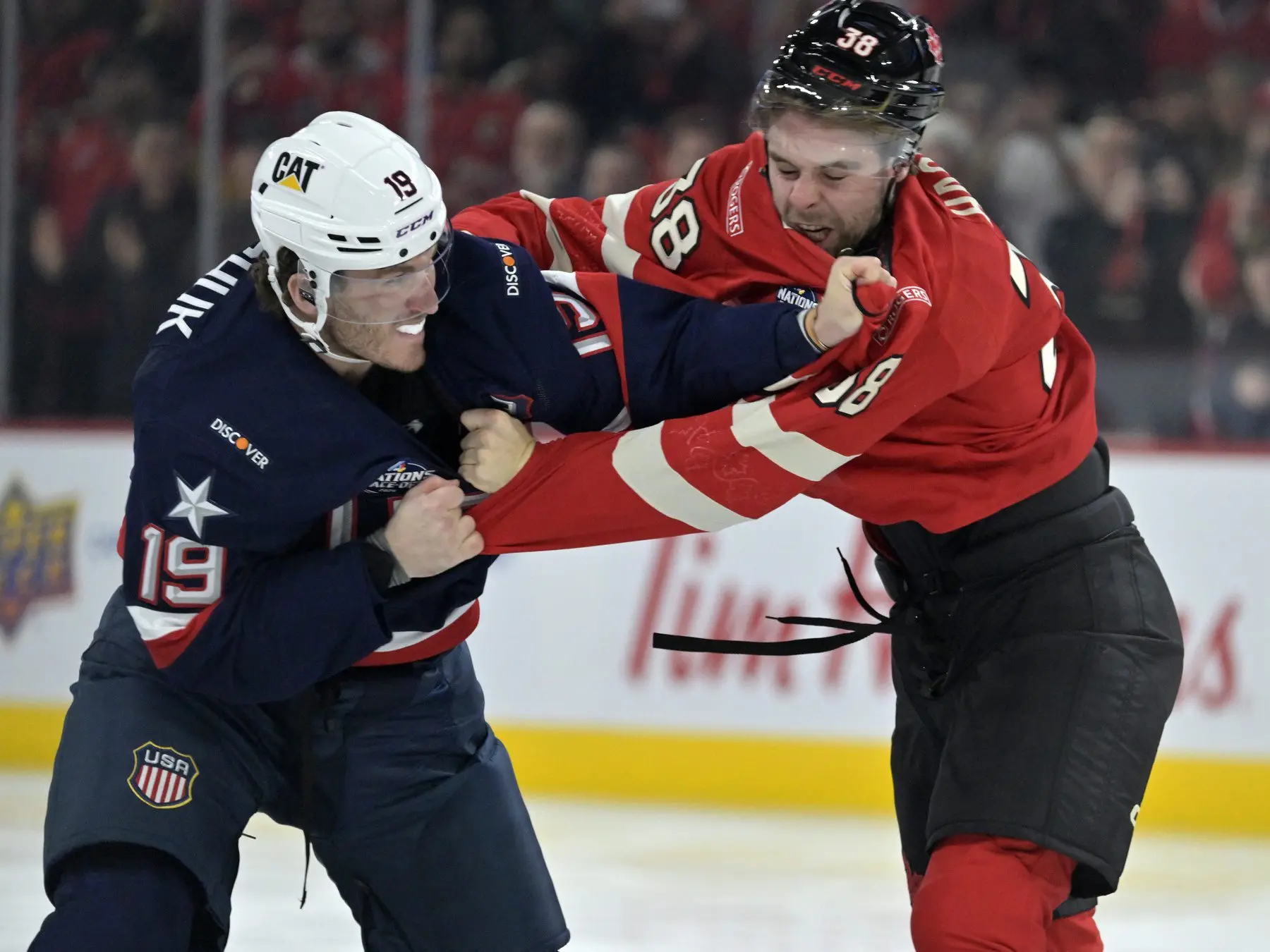 Team United States forward Matthew Tkachuk (19) and Team Canada forward brandon Hagel (38) fight in the first period during a 4 Nations Face-Off ice hockey game at the Bell Centre