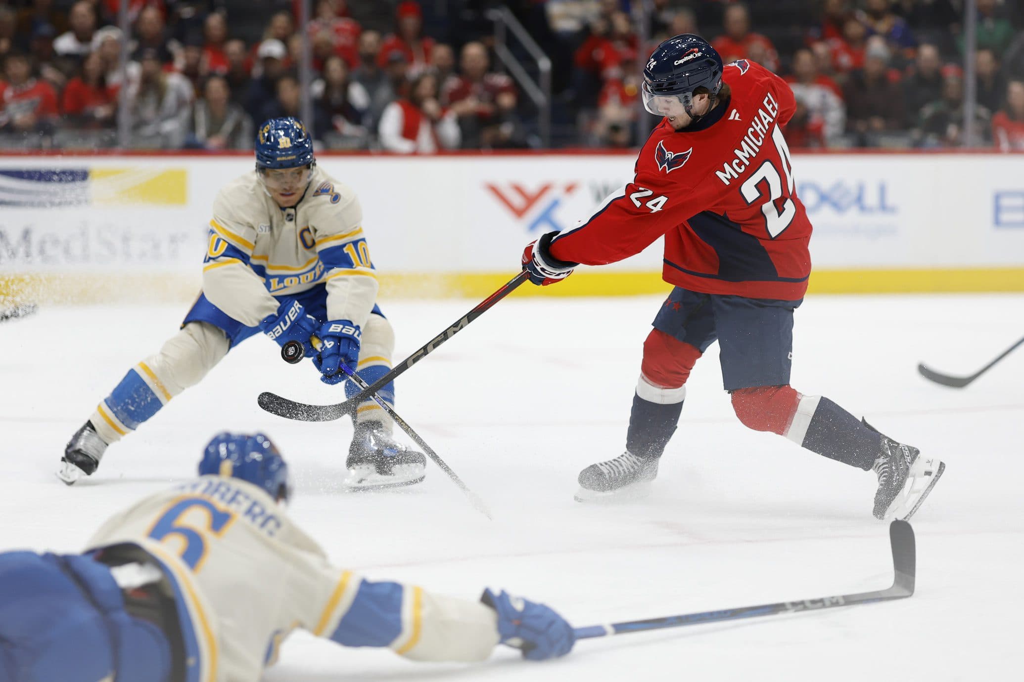 St. Louis Blues center Brayden Schenn (10) blocks the shot of Washington Capitals center Connor McMichael (24) as Blues defenseman Philip Broberg (6) defends in the third period at Capital One Arena