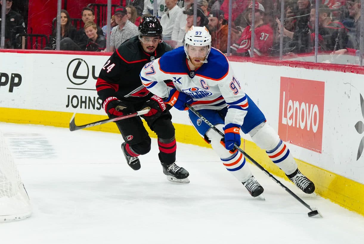 Edmonton Oilers center Connor McDavid (97) skates with the puck past Carolina Hurricanes center Seth Jarvis (24) during the second period at Lenovo Center