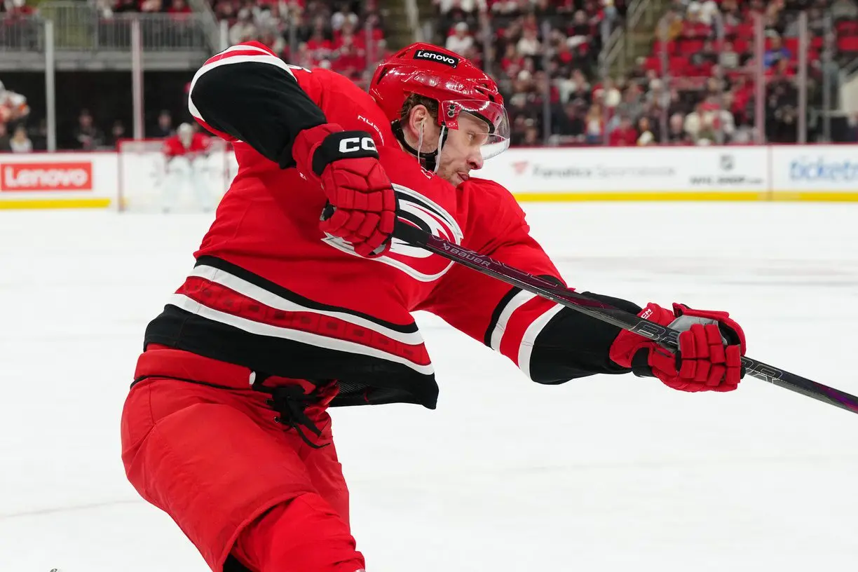 Carolina Hurricanes right wing Mikko Rantanen (96) takes a shot against the Calgary Flames during the first period at Lenovo Center.