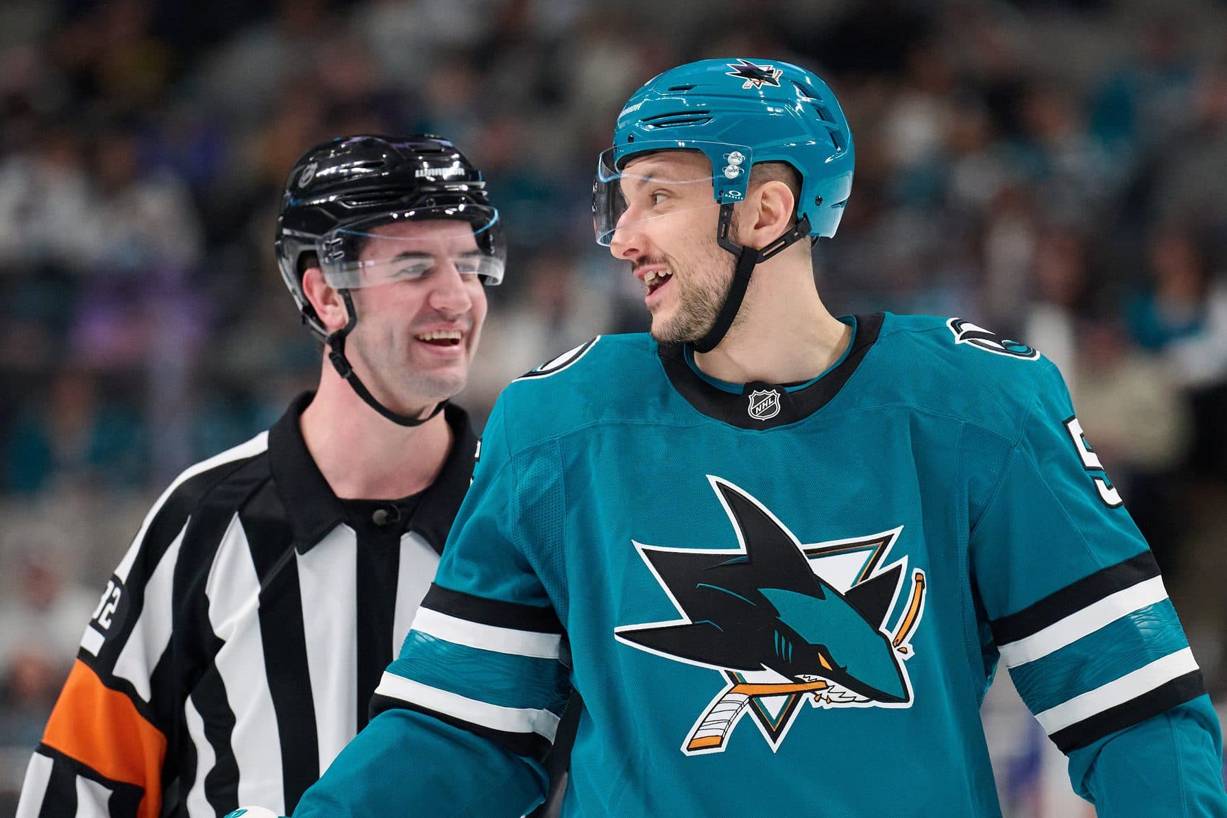 San Jose Sharks defenseman Vincent Desharnais (5) chats with referee Cody Beach (32) during a timeout against the New York Islanders in the first period at SAP Center at San Jose.