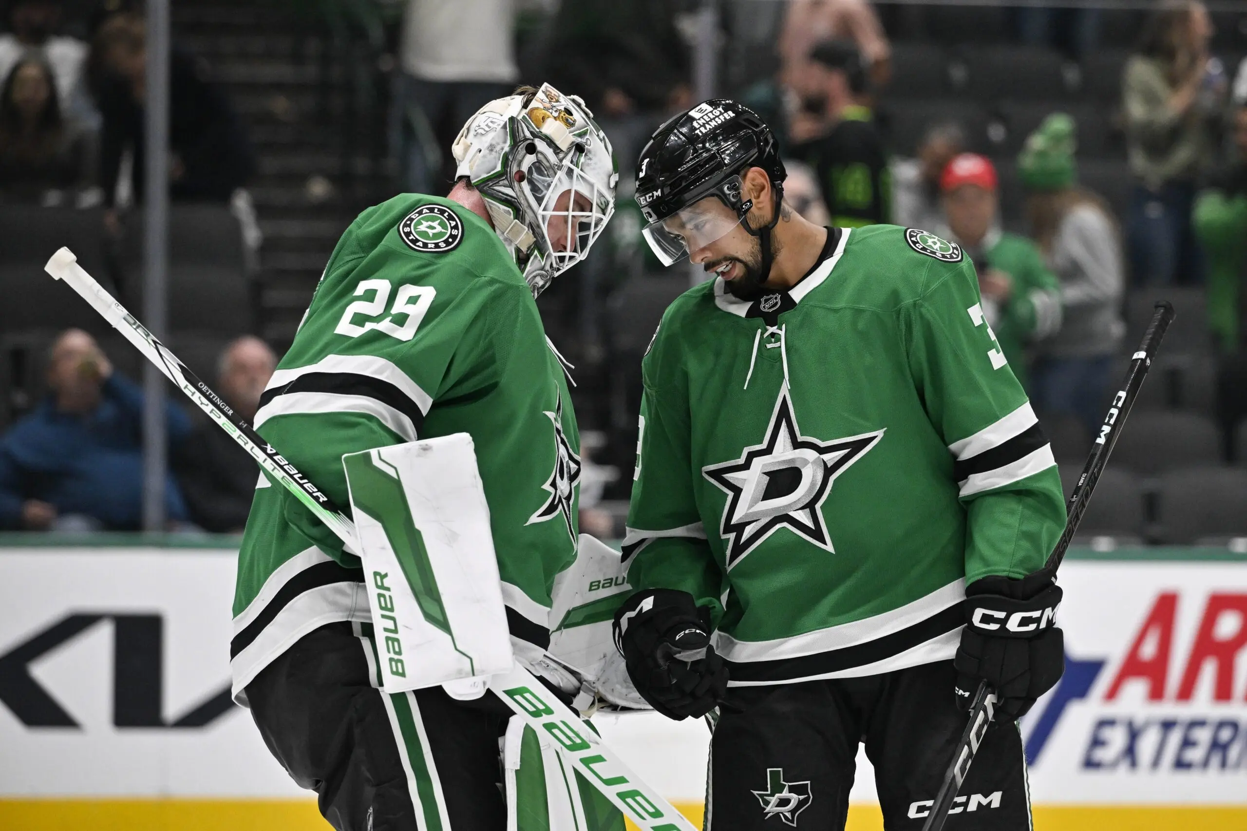 Dallas Stars goaltender Jake Oettinger (29) and defenseman Matt Dumba (3) celebrate the Stars victory of the Chicago Blackhawks at the American Airlines Center.