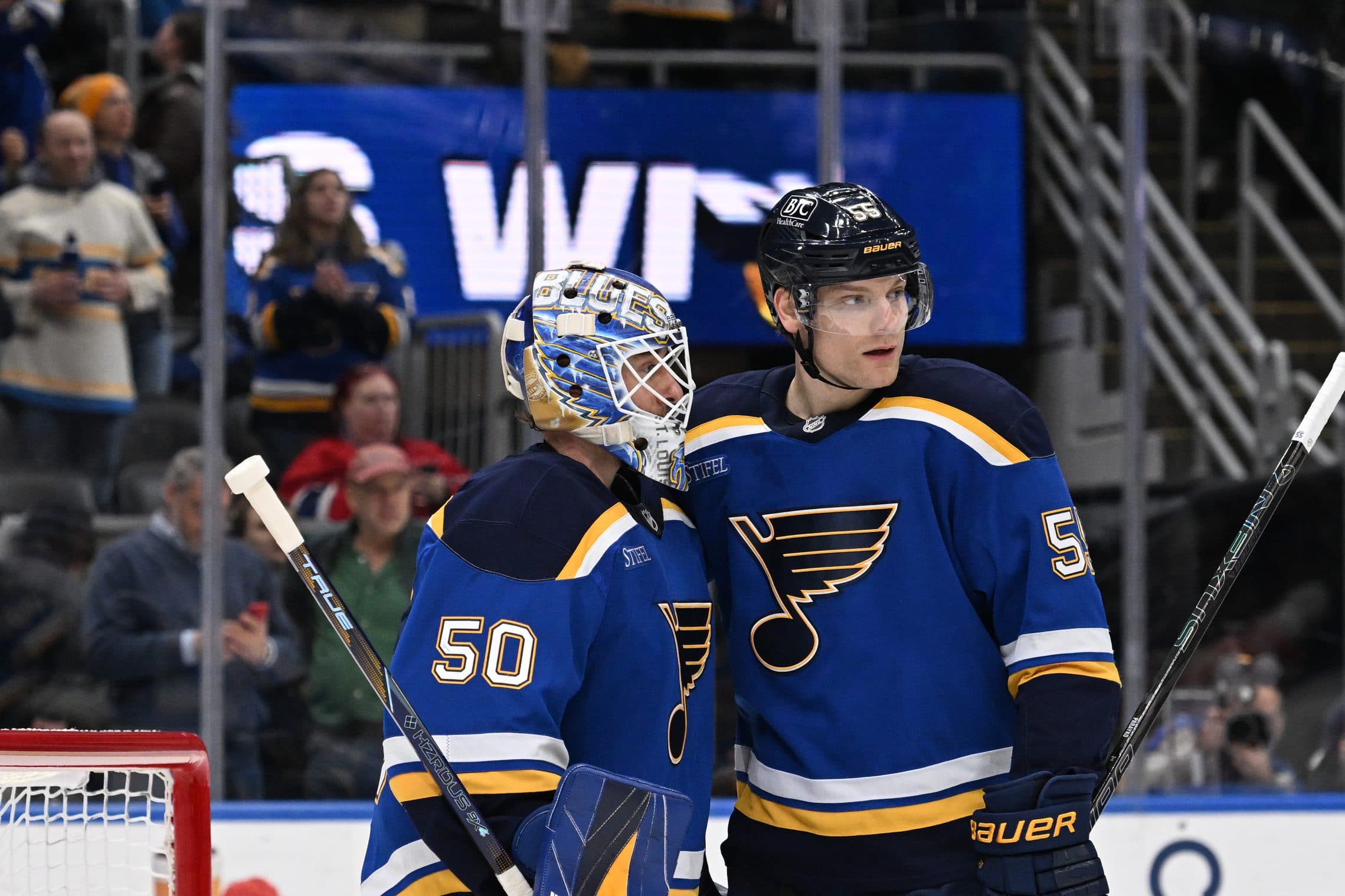 St. Louis Blues goaltender Jordan Binnington (50) and defenseman Colton Parayko (55) celebrate their teams 2-1 victory over the Calgary Flames at Enterprise Center