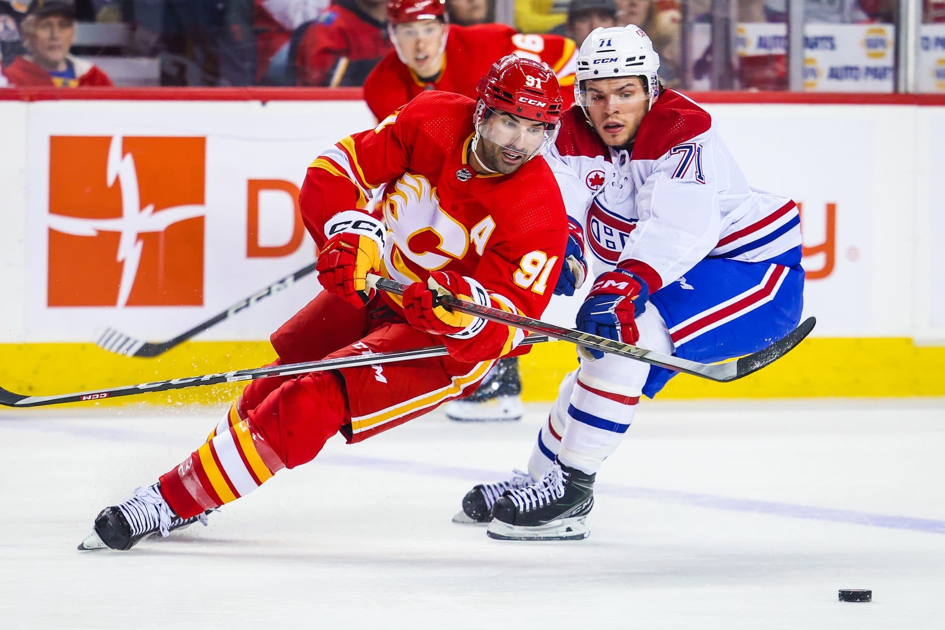 Calgary Flames center Nazem Kadri (91) and Montreal Canadiens center Jake Evans (71) battles for the puck during the second period at Scotiabank Saddledome.
