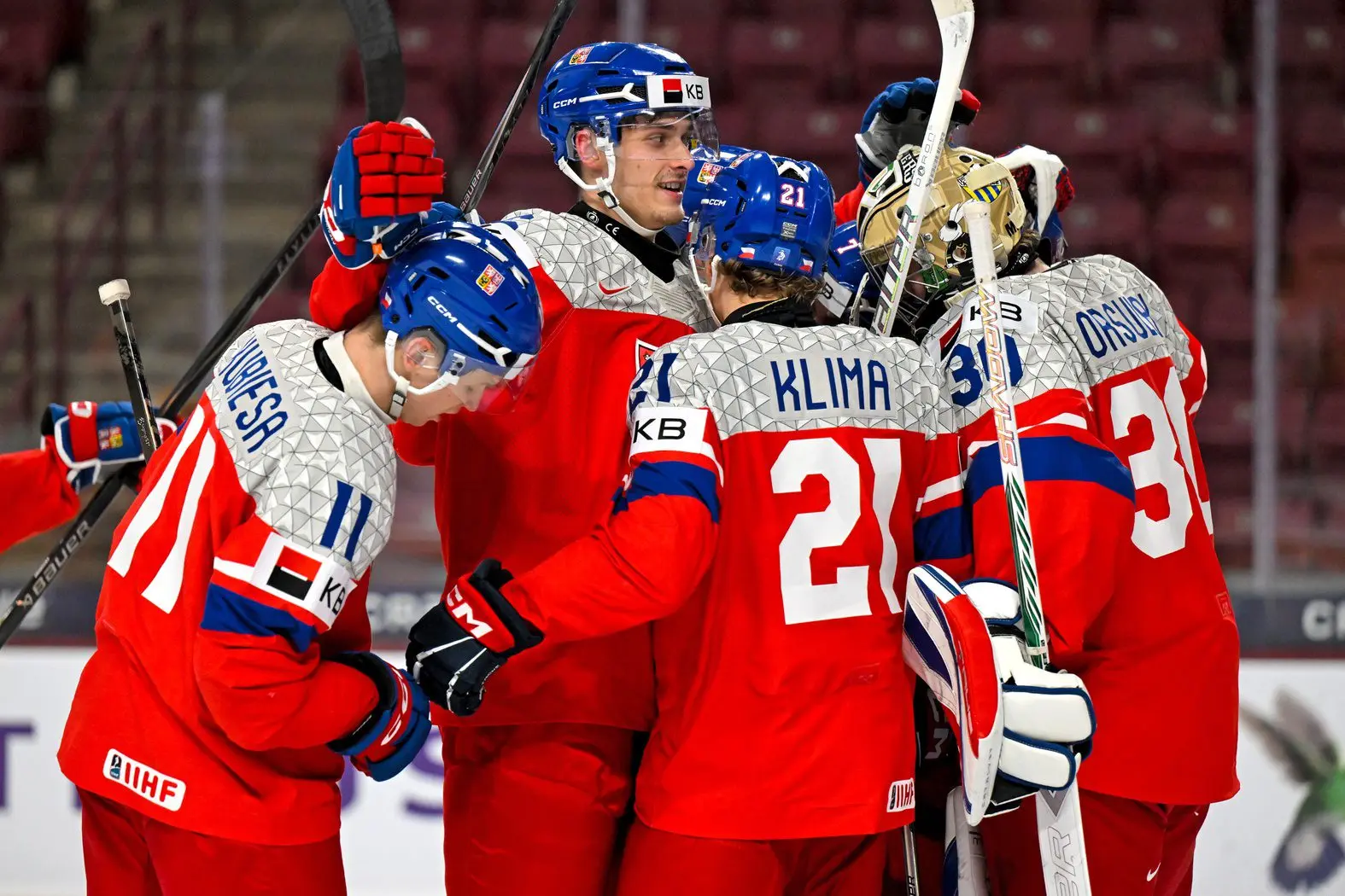 Czechia forward Matej Kubiesa (11), defensemen Radim Mrtka (6), forward Jiri Klima (21), and goalie Michal Orsulak (30) celebrate a victory over Switzerland in the quarterfinals of the 2026 IIHF World Junior Championship at 3M Arena.