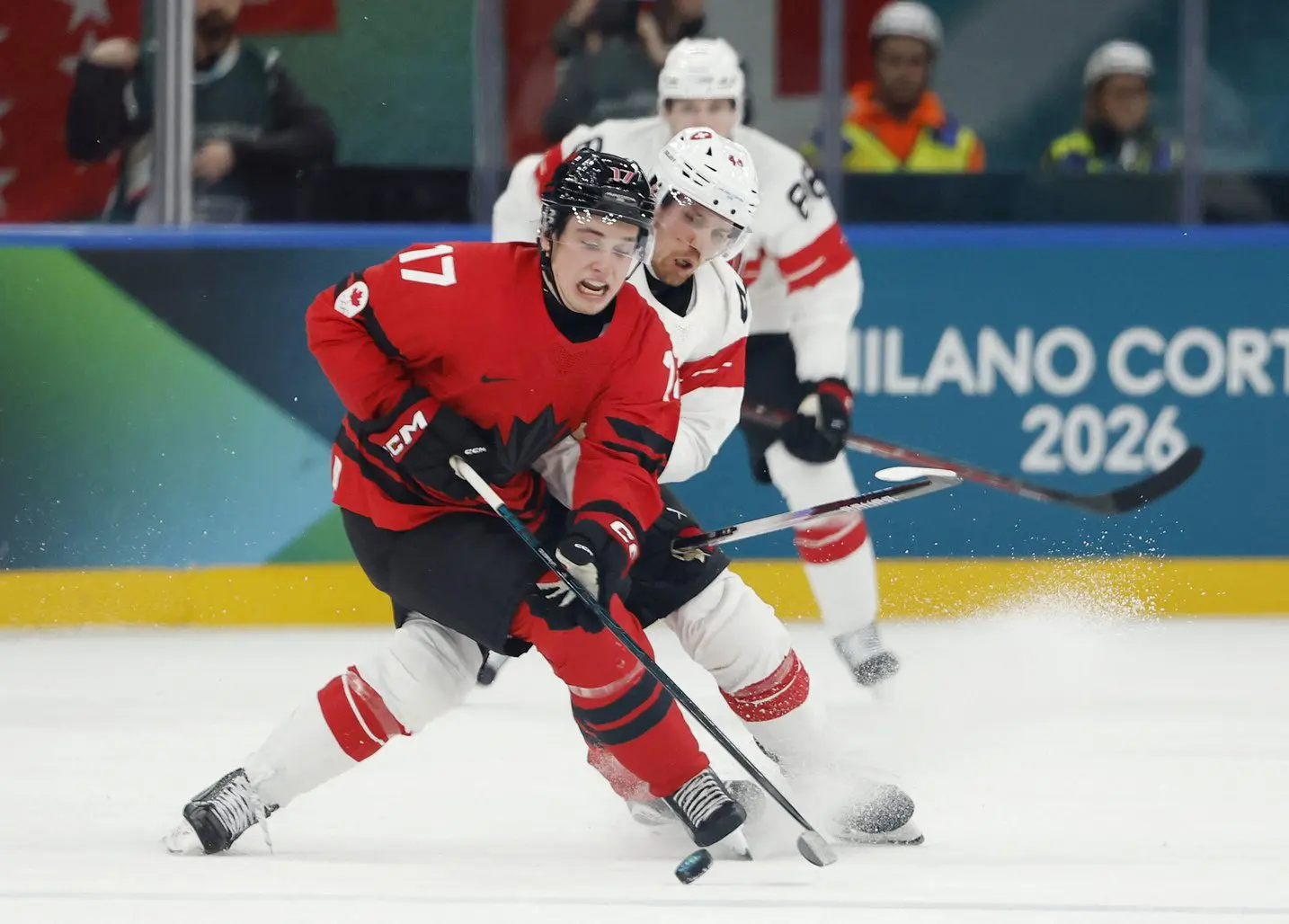 Macklin Celebrini of Canada in action with Pius Suter of Switzerland in men's ice hockey group A play during the Milano Cortina 2026 Olympic Winter Games at Milano Santagiulia Ice Hockey Arena.