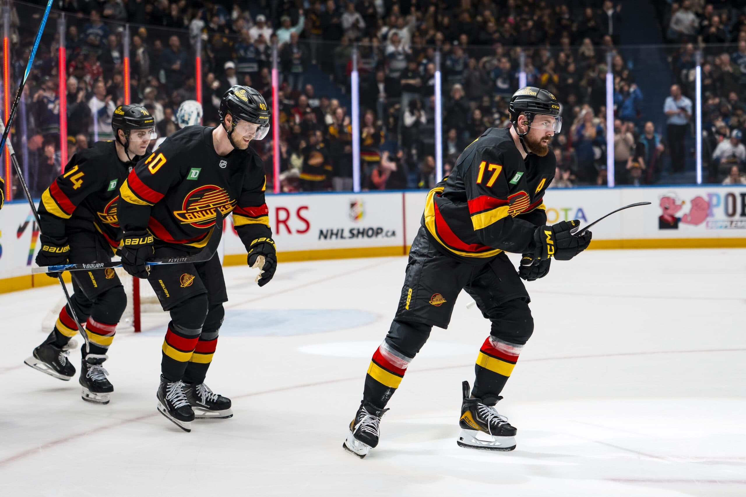 Vancouver Canucks forward Jake DeBrusk (74) and forward Elias Pettersson (40) and defenseman Filip Hronek (17) celebrate Hronek’s goal against the Washington Capitals in the second period at Rogers Arena.