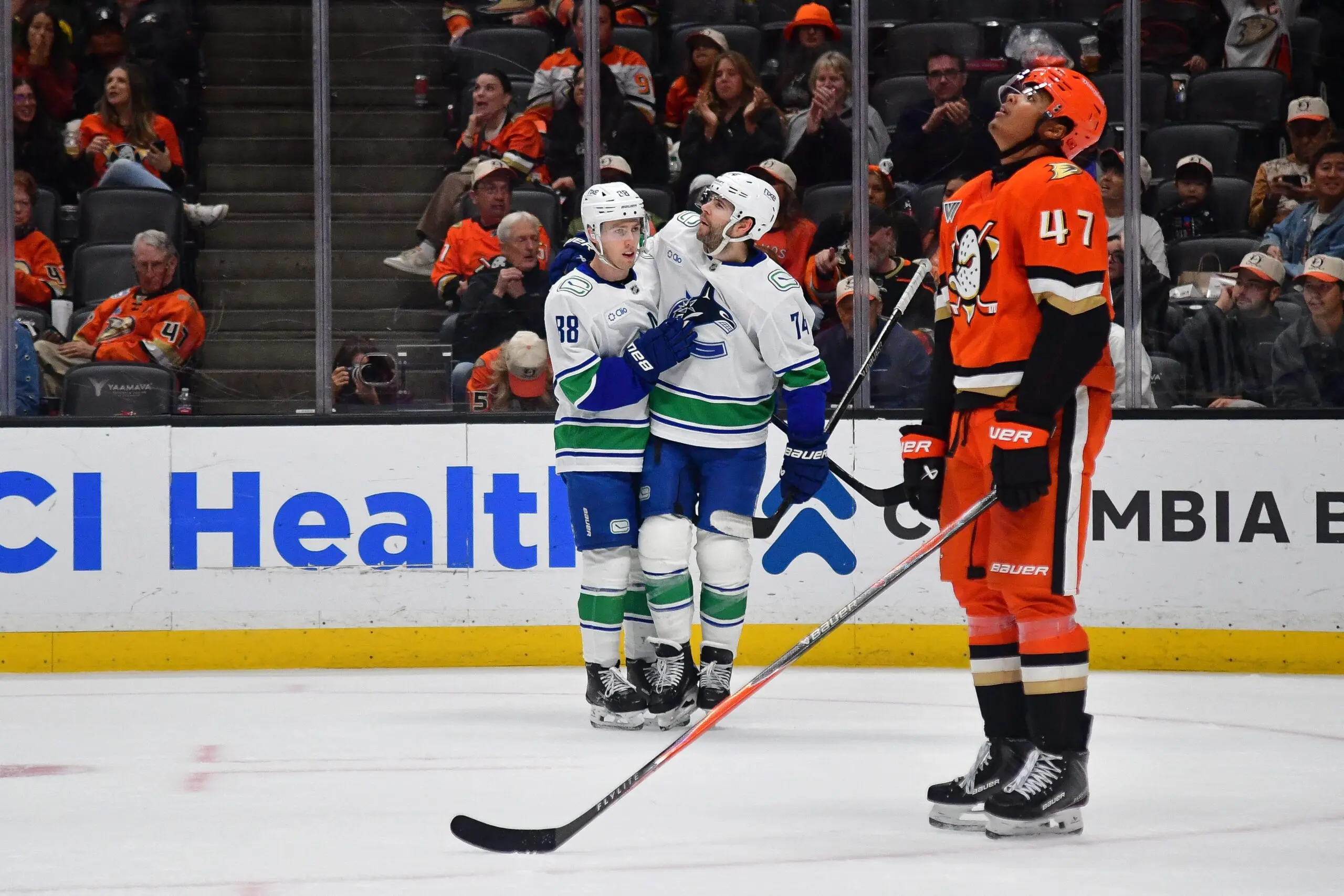 Vancouver Canucks right wing Jonathan Lekkerimaki (88) celebrates his goal scored against the Anaheim Ducks with left wing Jake DeBrusk (74) during the third period at Honda Center.